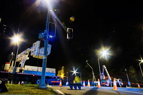 Workers installing traffic lights.