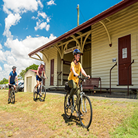 3 bicycle riders on trail