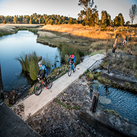 Bicycle riders crossing creek