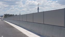 Composite panels used on a roadside noise barrier.