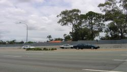 Galvanised steel panels on a roadside noise barrier.