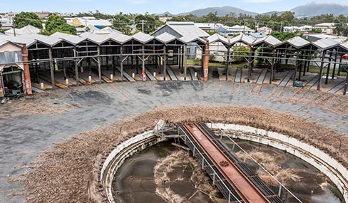 Close-up view of the historic, disused roundhouse at the Rockhampton Railyards Heritage site, featuring a circular structure with a stationary turntable in the center