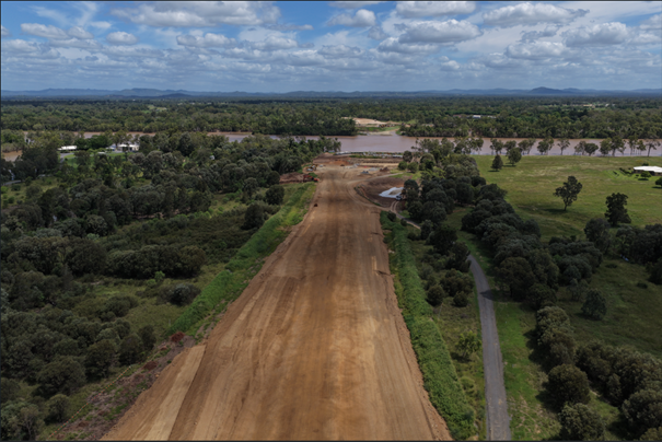 Shows the alignment of the Rockhampton Ring Road looking southwest from the Parkhurst side of the Fitzroy River. Fore- and midground shows the cleared road corridor for construction of the Rockhampton Ring Road at Parkhurst approaching the Fitzroy River from the north. In the background is the Fitzroy River (horizontal across image) indicating where the exclusion zone will be in place.