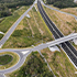 Aerial view of the Gympie Bypass New Flood Road Interchange, featuring a large overpass and a roundabout connecting to the Bruce Highway. 