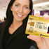 A person holding up a driver's licence in an office.