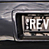 A black car with a license plate with the letters qld rev.