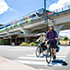Bicycle rider with train in background