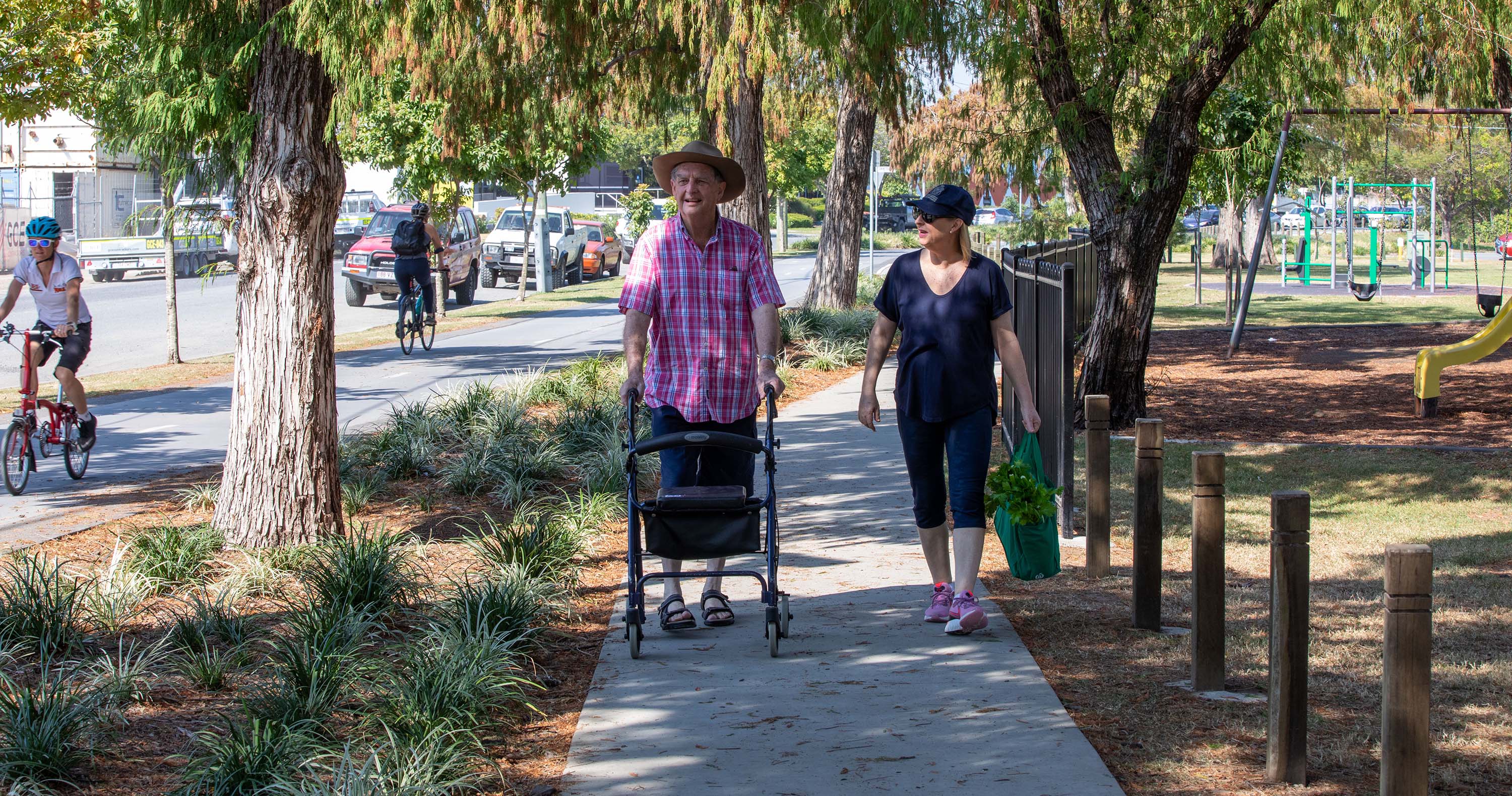 Bicycle riders and pedestrians using the separated cycle track and footpath near Windsor Park, McDonald Road