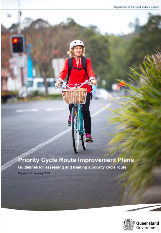 Person in red jacket riding bicycle 