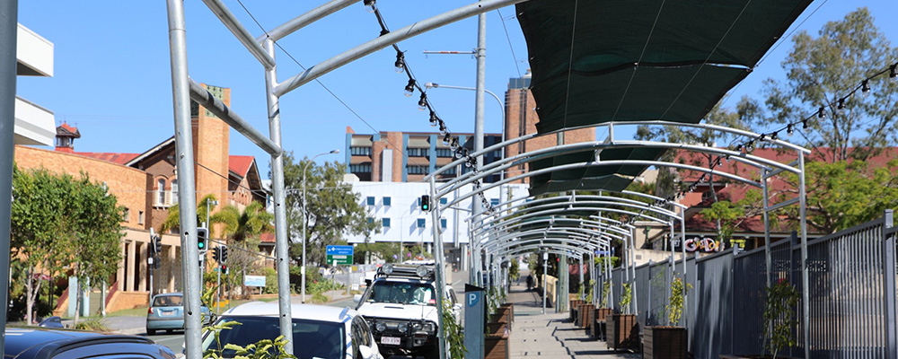 A temporary shade structure covering a footpath between Ipswich Hospital and Ipswich city centre.