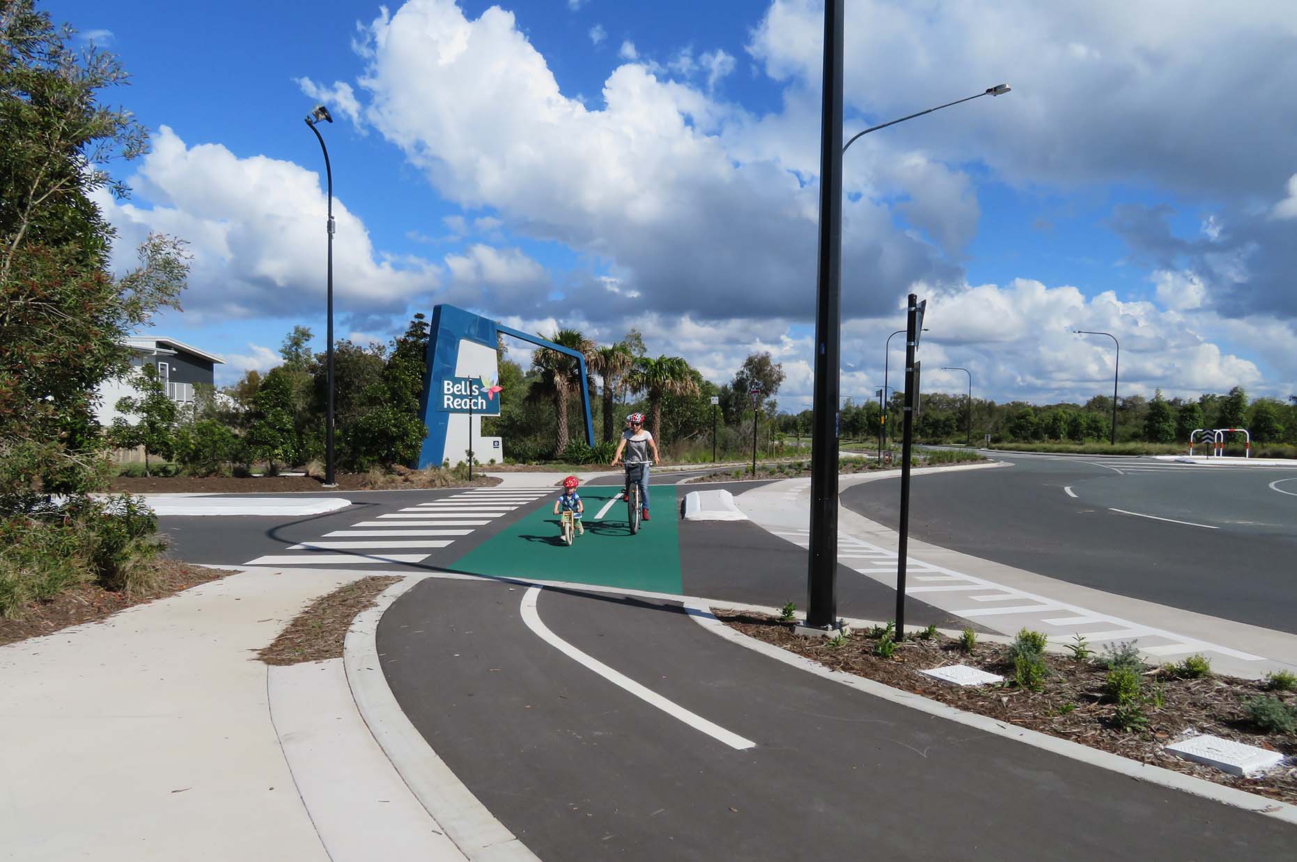 adult and child riding their bicycles in a bicycle lanes